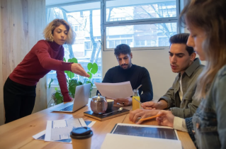2 Men and a Woman at a Small Conference Table